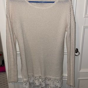 Cream sweater with floral detailing on the bottom